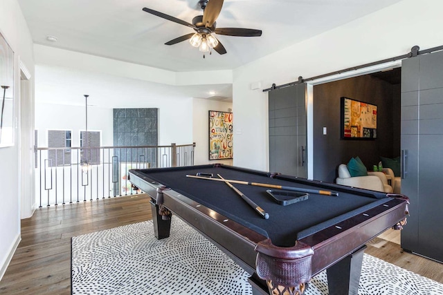 recreation room with hardwood / wood-style floors, pool table, a barn door, and ceiling fan