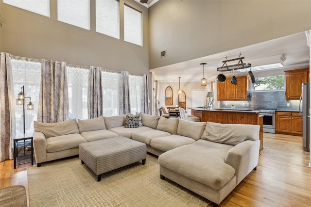 living area featuring light wood-type flooring and visible vents