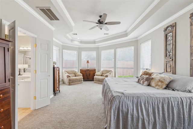 bedroom featuring a tray ceiling, visible vents, ornamental molding, a ceiling fan, and light carpet