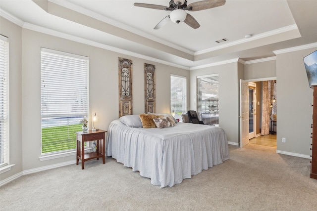 bedroom with baseboards, visible vents, a raised ceiling, and light colored carpet