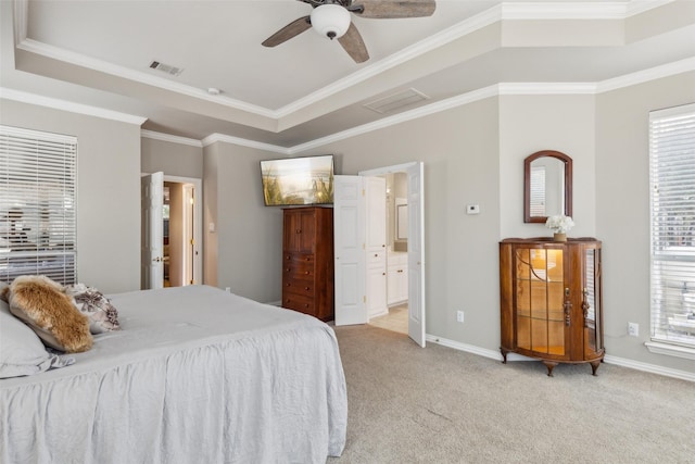 bedroom with multiple windows, baseboards, a raised ceiling, and light colored carpet