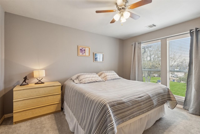 bedroom with carpet floors, visible vents, and a ceiling fan