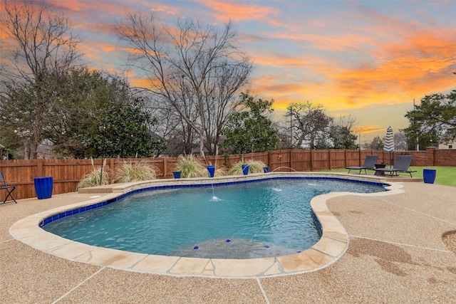 pool at dusk featuring a patio, a fenced backyard, and a fenced in pool