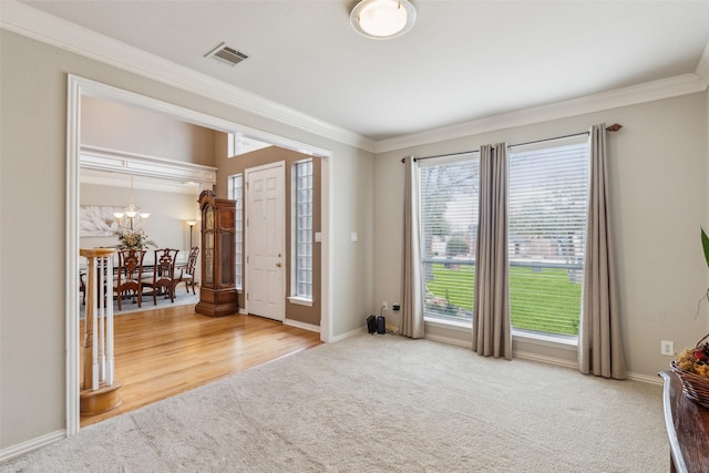 interior space featuring ornamental molding, visible vents, and baseboards