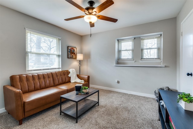 living room with plenty of natural light, light colored carpet, and ceiling fan