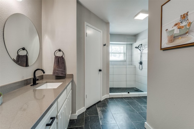 bathroom with vanity and a tile shower