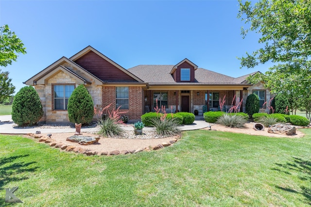 158 Stardust Trl, Tuscola, TX 79562 - view of front facade with a front yard, brick siding, stone siding, and covered porch