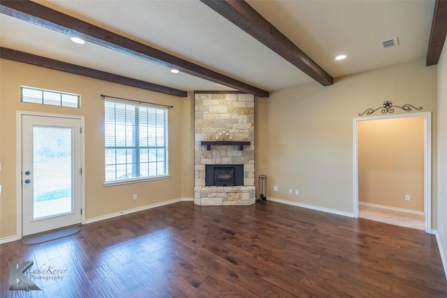 unfurnished living room with a fireplace, dark hardwood / wood-style floors, and beamed ceiling