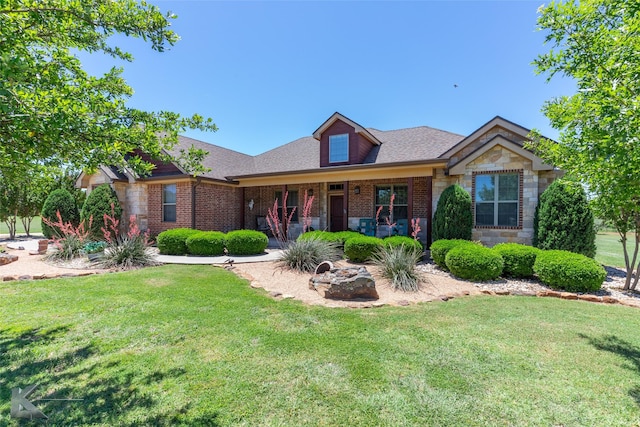 158 Stardust Trl, Tuscola, TX 79562 - view of front facade with a front lawn, brick siding, covered porch, and stone siding