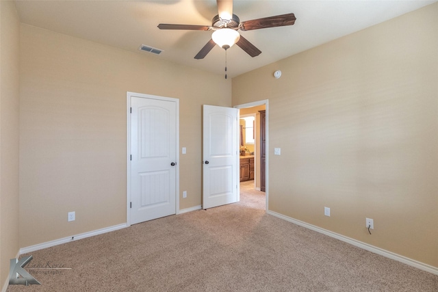 unfurnished bedroom featuring ceiling fan and light colored carpet