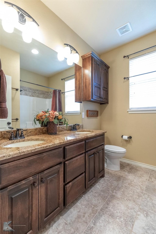 bathroom featuring vanity, toilet, and a shower with shower curtain