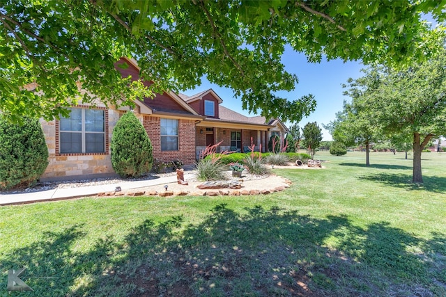 158 Stardust Trl, Tuscola, TX 79562 - view of front facade with a front yard, brick siding, and covered porch