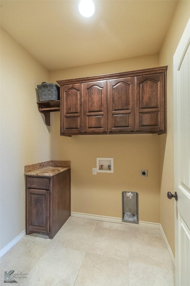 clothes washing area featuring cabinets, hookup for an electric dryer, and hookup for a washing machine