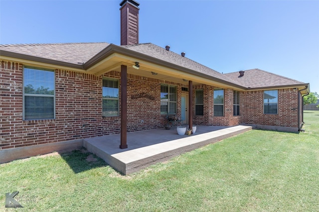 158 Stardust Trl, Tuscola, TX 79562 - rear view of house featuring brick siding, a patio, a lawn, a chimney, and roof with shingles