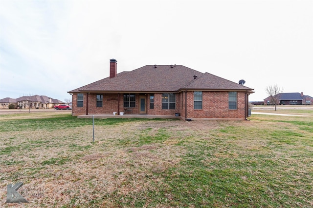 rear view of house with a lawn