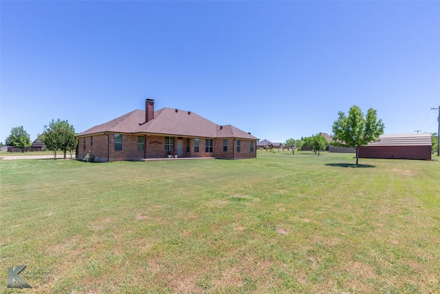 158 Stardust Trl, Tuscola, TX 79562 - rear view of property with a yard, a chimney, and brick siding