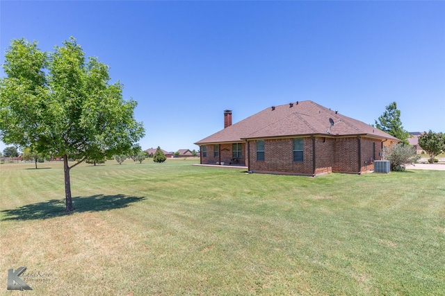 158 Stardust Trl, Tuscola, TX 79562 - rear view of house featuring central AC, a chimney, and a yard