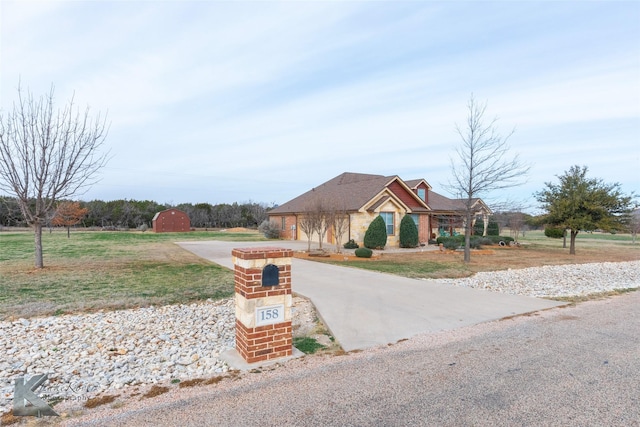 single story home with a garage and a front lawn