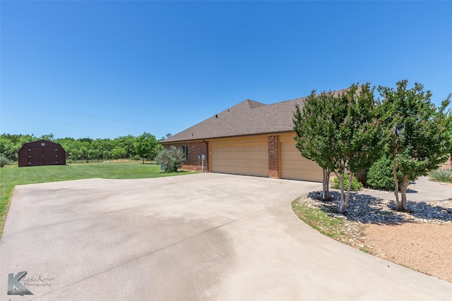 158 Stardust Trl, Tuscola, TX 79562 - view of front of house with brick siding, a front lawn, concrete driveway, a garage, and a shingled roof