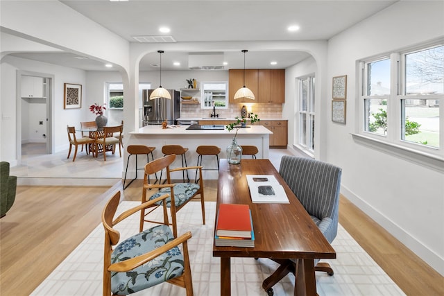 dining room featuring sink and light wood-type flooring