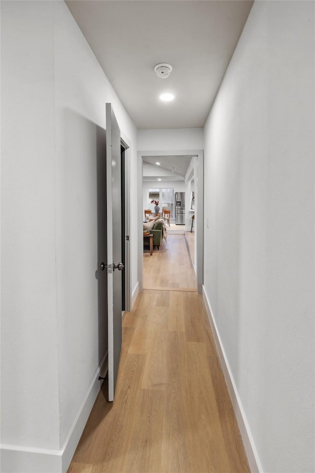 corridor with light hardwood / wood-style flooring