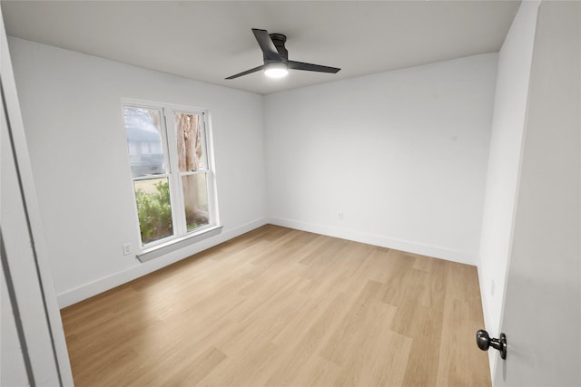 spare room with ceiling fan and light wood-type flooring