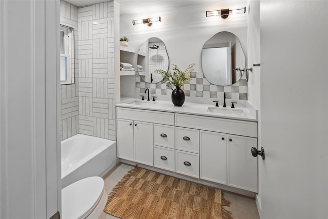 full bathroom featuring tiled shower / bath, vanity, toilet, and decorative backsplash