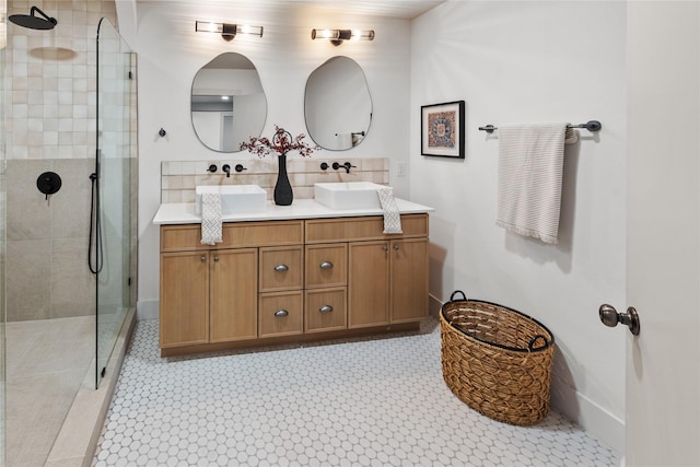 bathroom featuring tiled shower and vanity