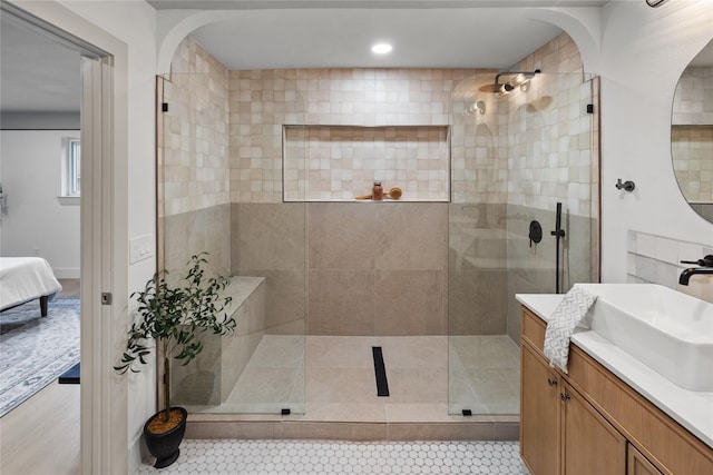 bathroom with vanity and a tile shower