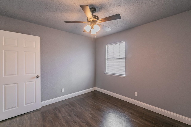 empty room featuring dark wood-type flooring, a textured ceiling, and ceiling fan