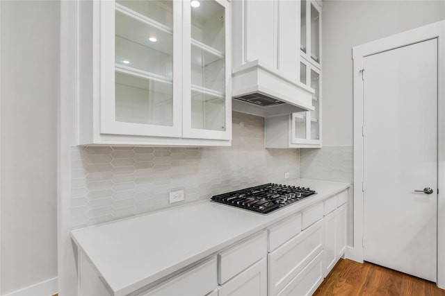625 N Tyler St Unit 402, Dallas, TX 75208 - kitchen with white cabinets, light countertops, stainless steel gas stovetop, and dark wood-type flooring