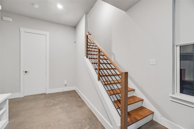 625 N Tyler St Unit 402, Dallas, TX 75208 - stairway featuring baseboards and concrete floors
