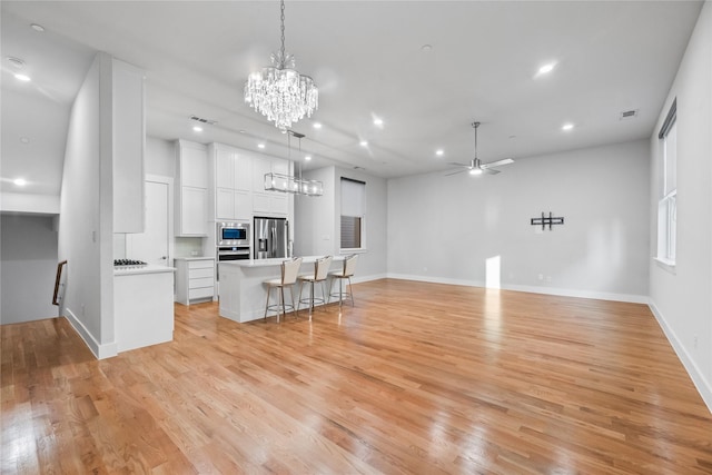 625 N Tyler St Unit 402, Dallas, TX 75208 - unfurnished living room featuring visible vents, baseboards, ceiling fan with notable chandelier, recessed lighting, and light wood-style flooring