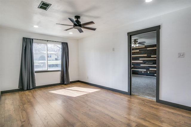 unfurnished room featuring light hardwood / wood-style flooring and ceiling fan