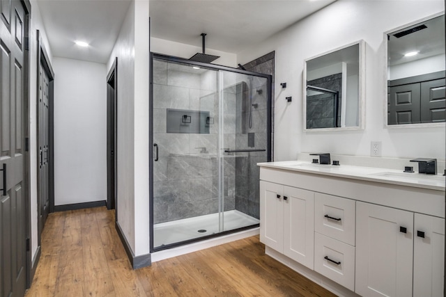 bathroom with vanity, hardwood / wood-style floors, and walk in shower