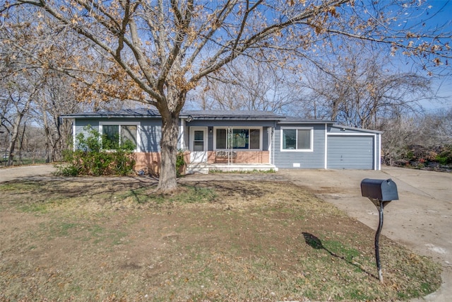 single story home featuring a porch, a garage, and a front yard