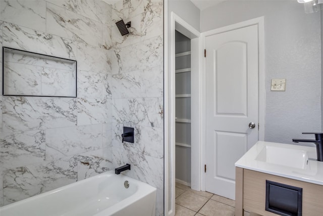 bathroom with vanity, tile patterned flooring, and tiled shower / bath