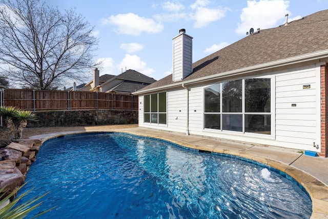 view of swimming pool with a patio area, fence, and a fenced in pool