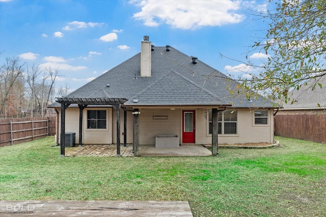 back of property with central AC unit, a yard, and a patio