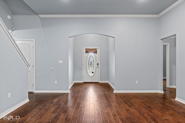 entryway with ornamental molding and dark hardwood / wood-style floors