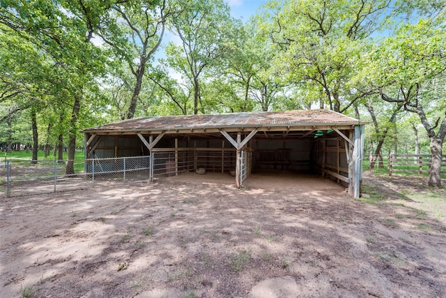 view of outbuilding featuring a carport, an outdoor structure, and an exterior structure