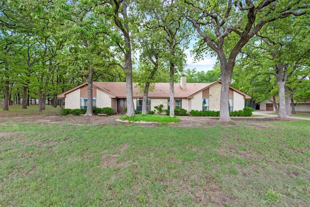 view of front of house with a front lawn and a chimney