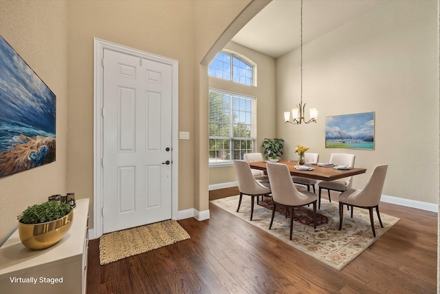 1555 Sonnet Dr, Heath, TX 75126 - foyer entrance featuring dark wood finished floors, a chandelier, arched walkways, baseboards, and a towering ceiling