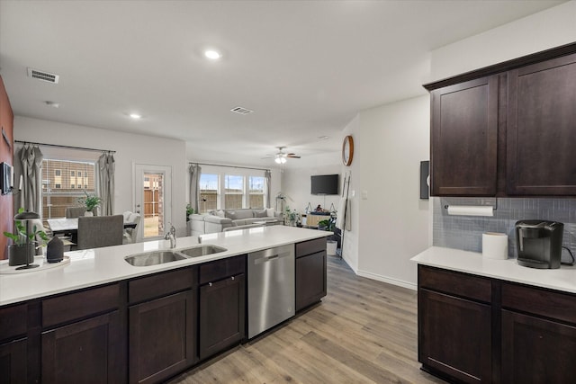 kitchen with dark brown cabinetry, sink, light hardwood / wood-style flooring, dishwasher, and backsplash