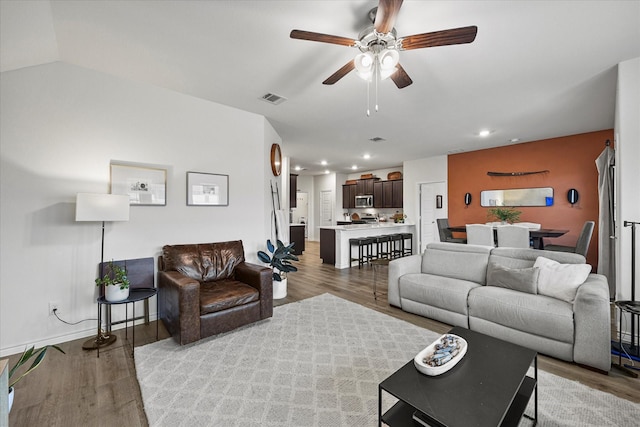 living room featuring light hardwood / wood-style floors and ceiling fan