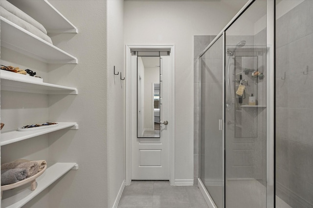 bathroom featuring a shower with door