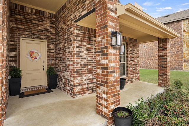 126 Condor Pass, Caddo Mills, TX 75135 - view of exterior entry featuring brick siding and a porch