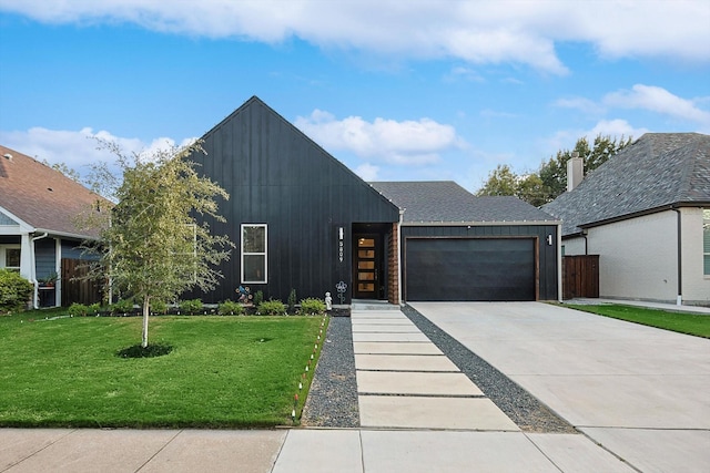 view of front of house with a garage and a front yard