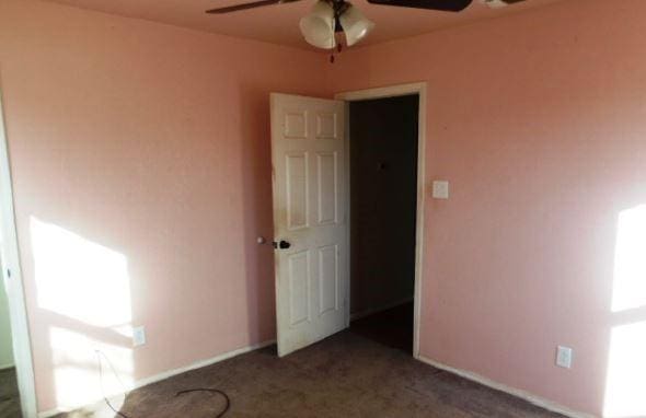 carpeted empty room with ceiling fan