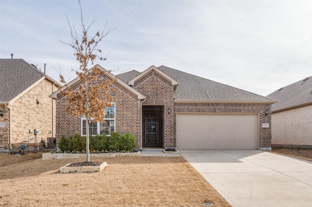 view of front of home featuring a garage and central air condition unit